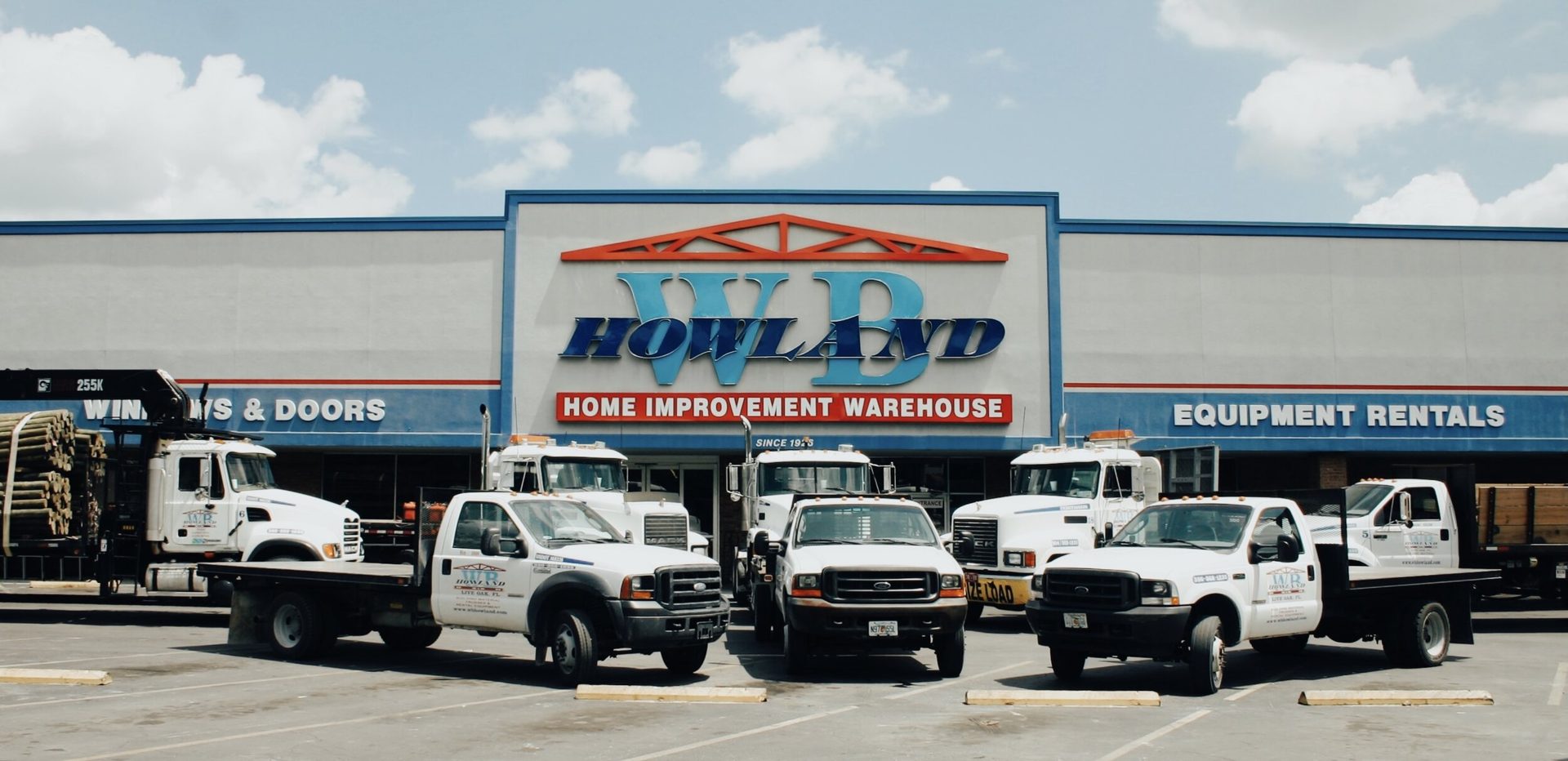 WB Howland Home Improvement Warehouse storefront with the delivery fleet in Live Oak, FL